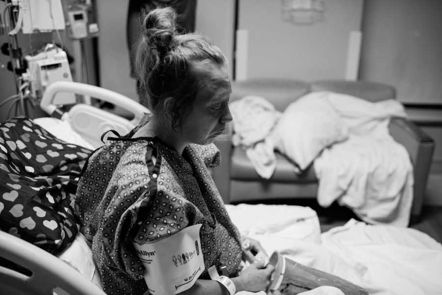 Woman who gave up her baby for adoption sits up in hospital bed with sad face