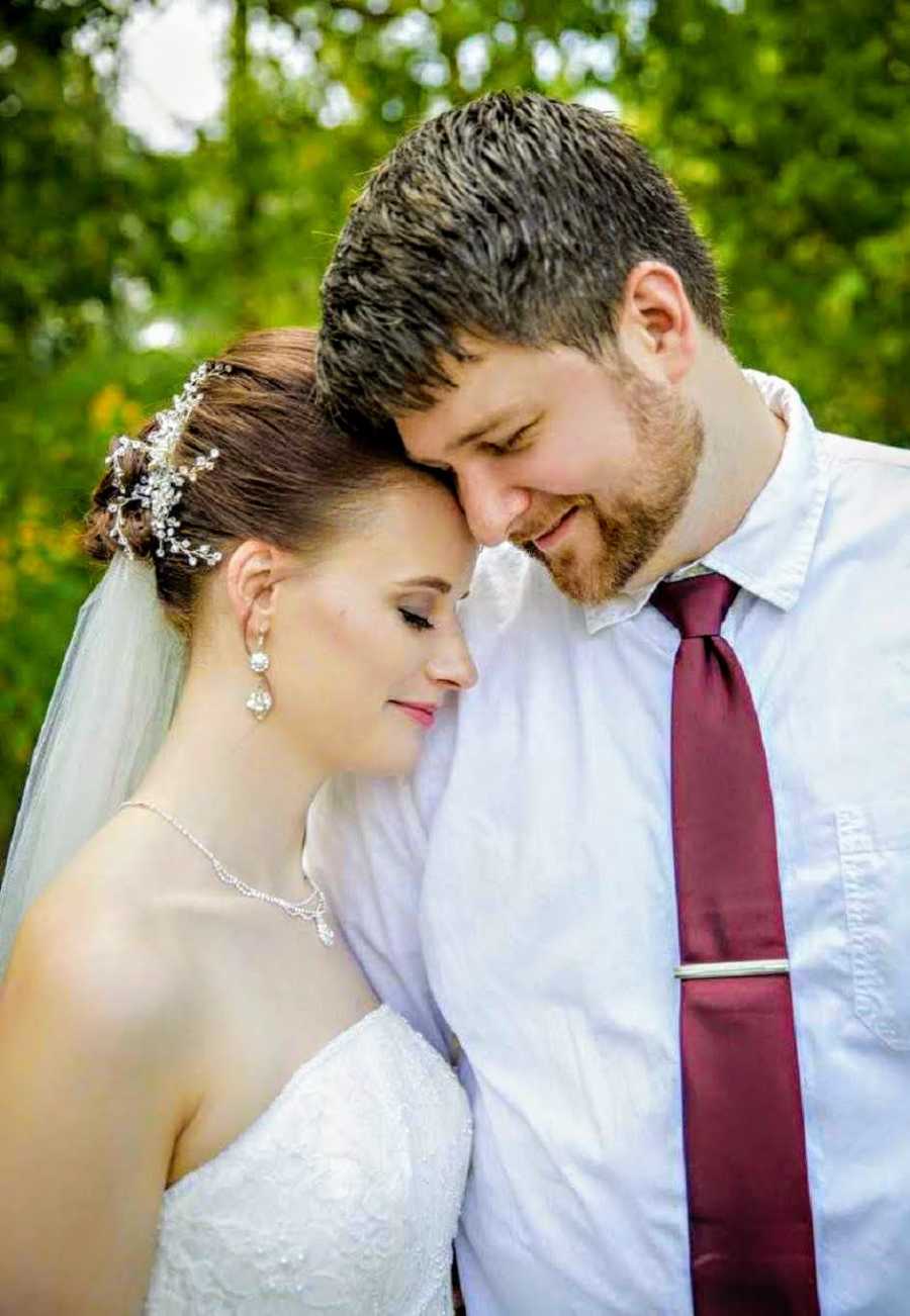 Groom whose childhood home burned down smiles as she rests his head on his bride
