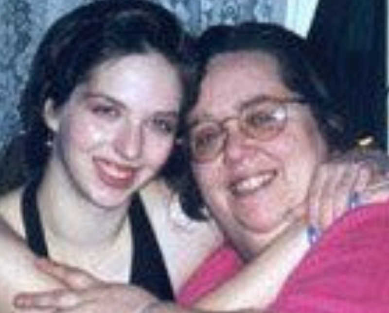 Teen who had an abortion sits smiling with arms around her mother