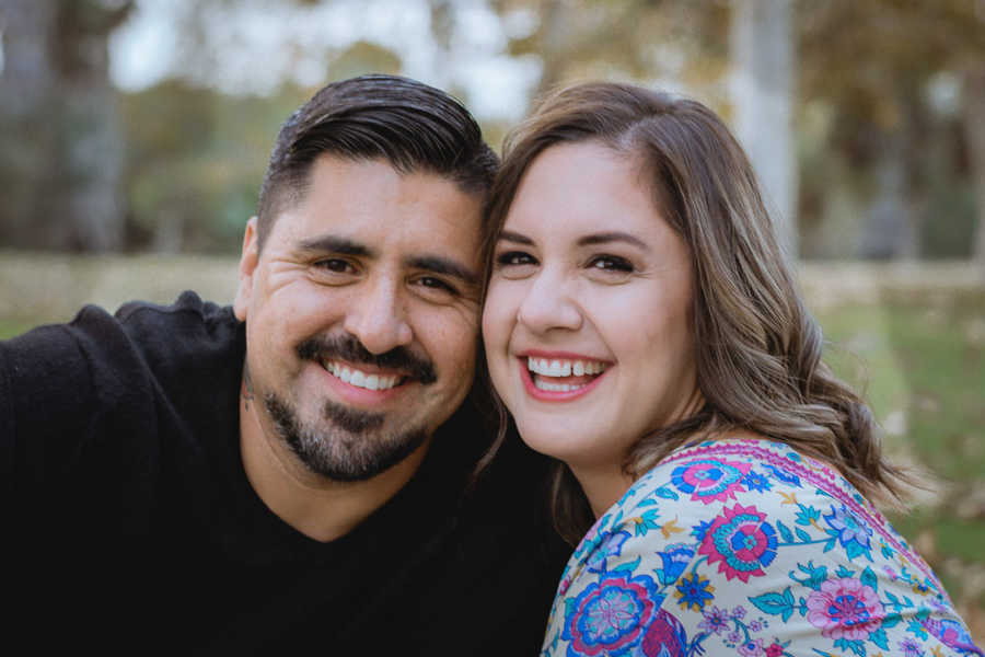 Divorced woman smiles as she sits outside beside boyfriend