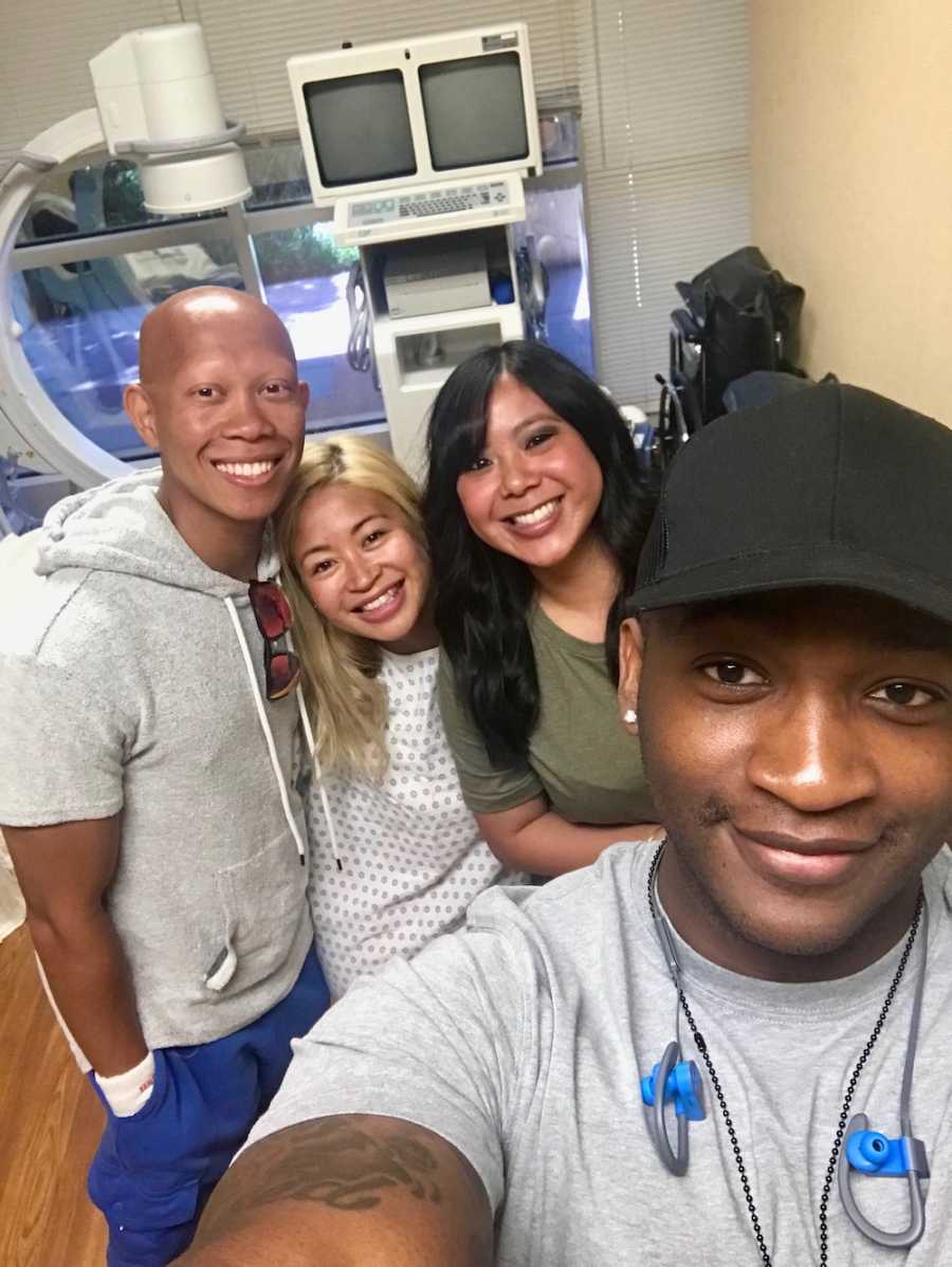 Husband takes selfie with wife, their surrogate and the surrogates husband in hospital room