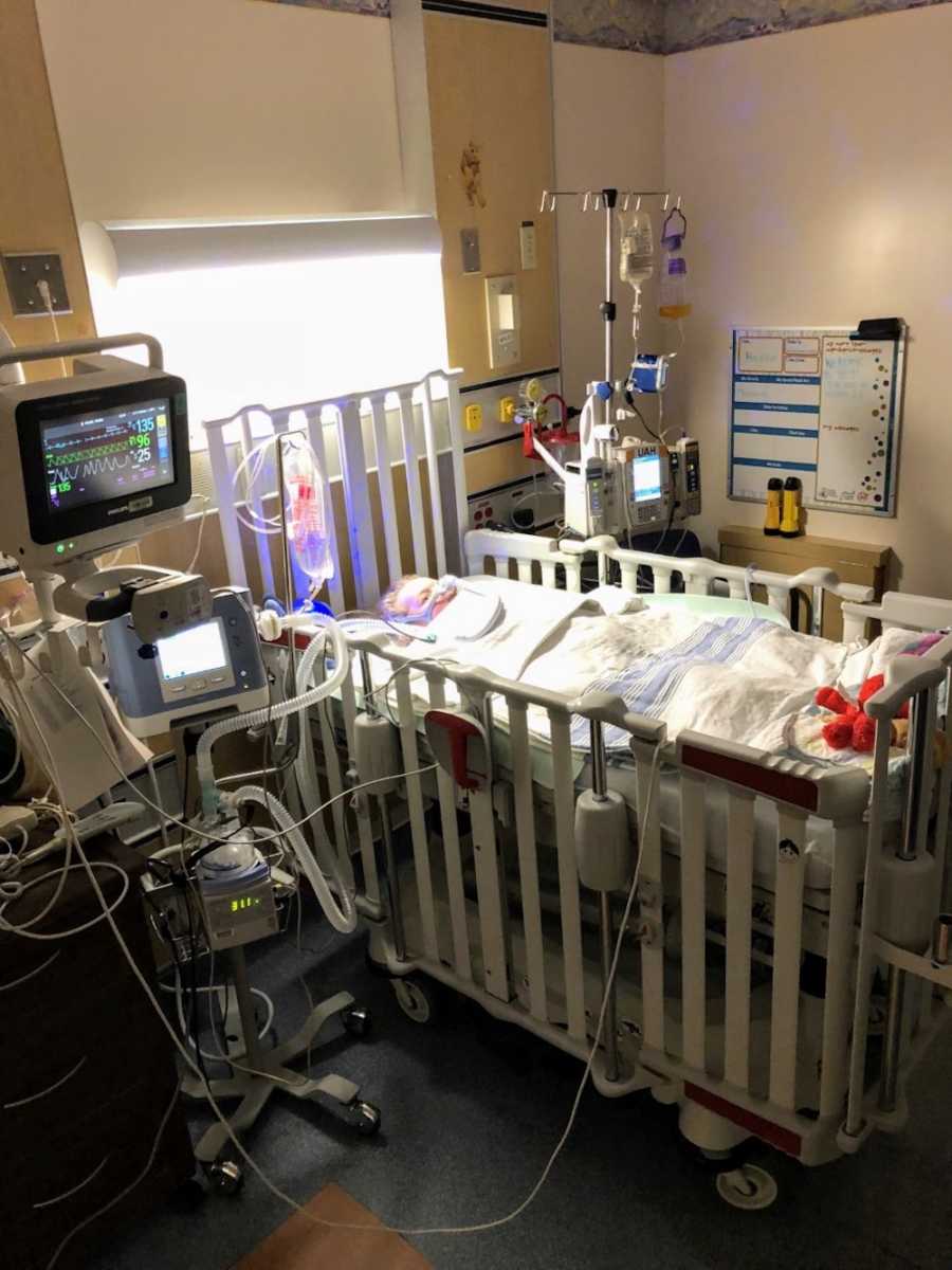 Intubated baby girl lays in hospital crib after having seizure