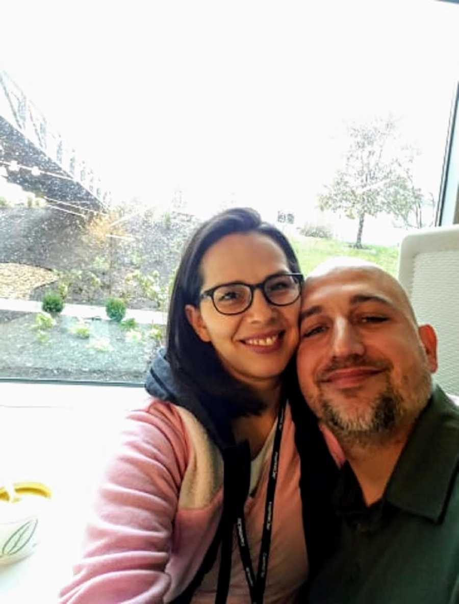 Woman smiles in selfie with her husband after miscarriage