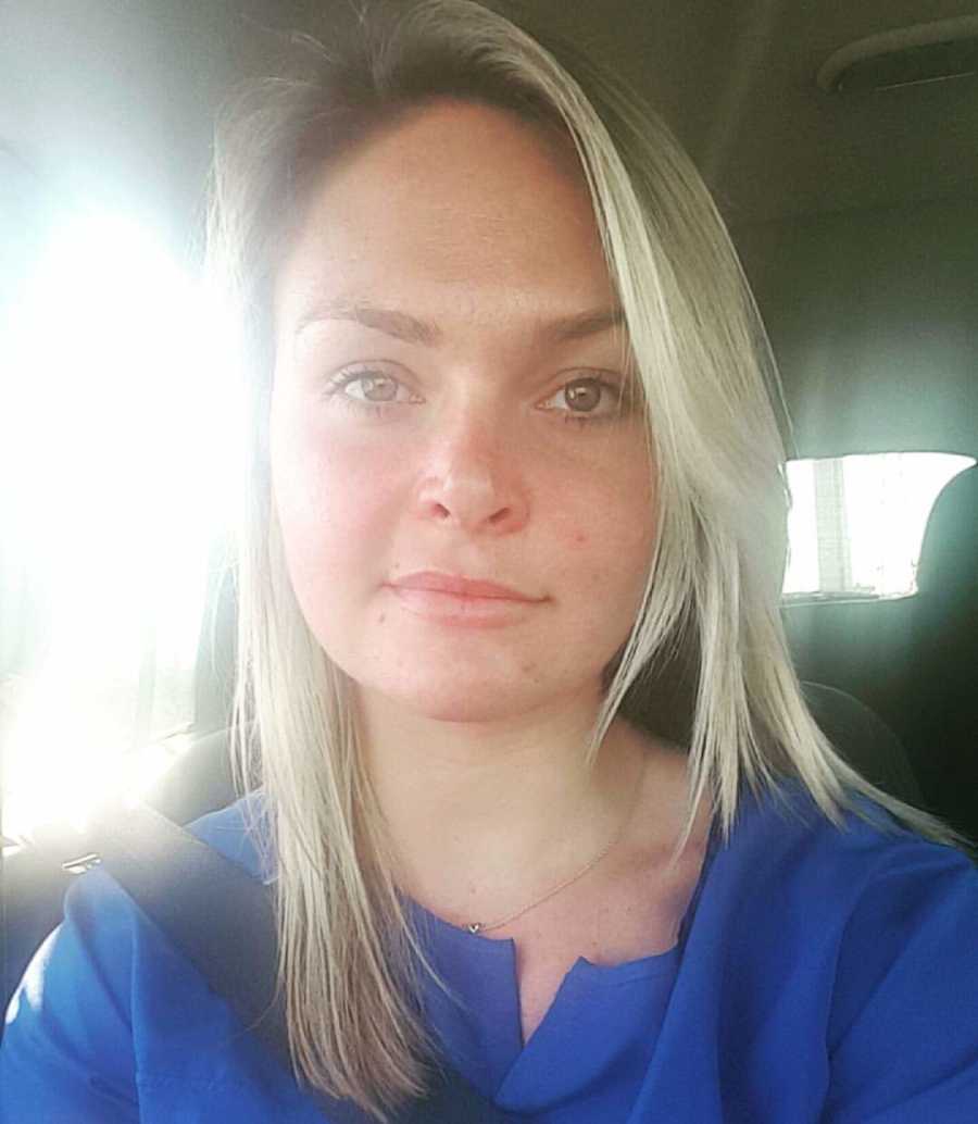 Woman whose husband divorced her sits in car as she takes selfie