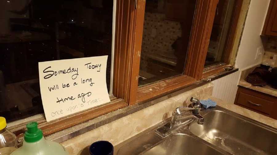 Piece of paper on window sill of kitchen that says, "someday today will be a long time ago"