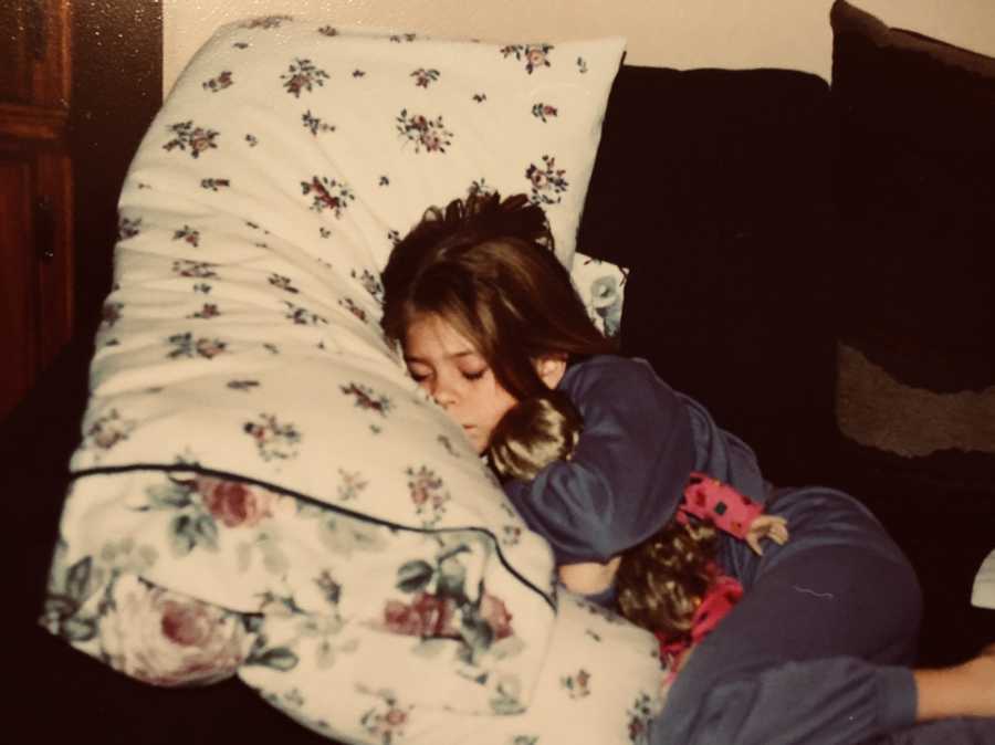 Little girl lays asleep on couch who will face parental abuse in her life