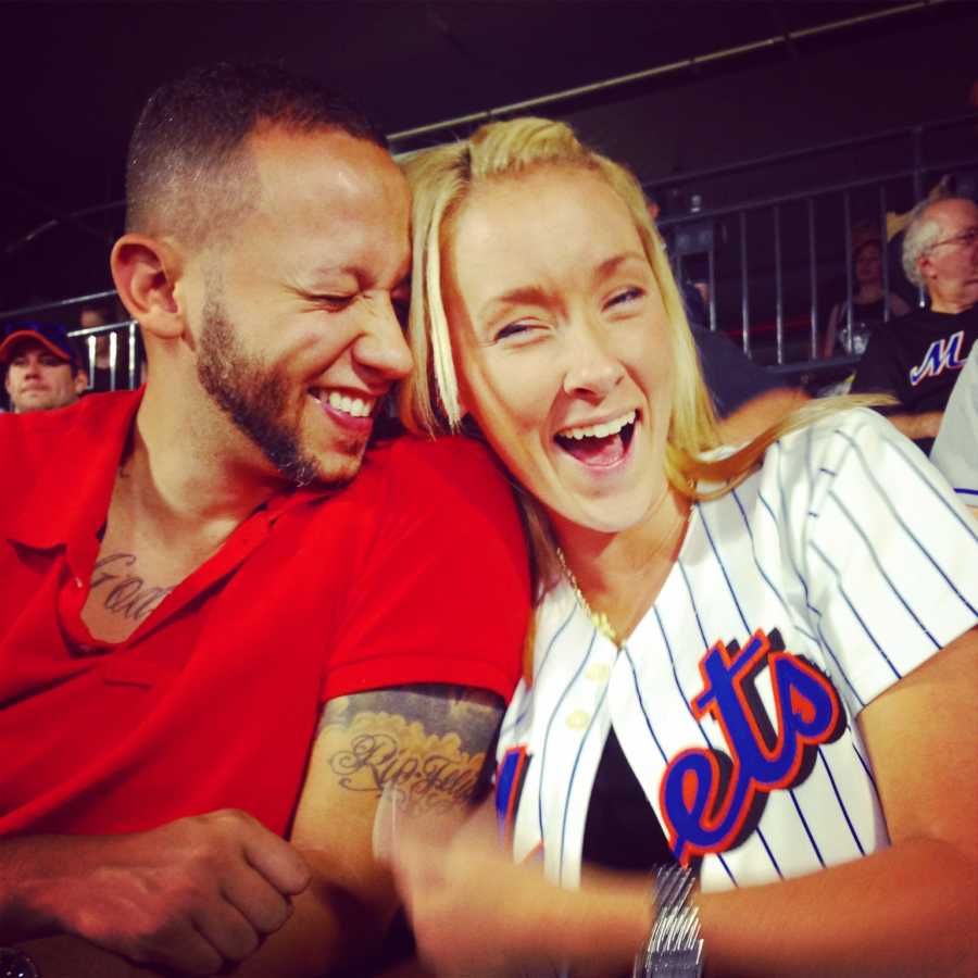 Man smiles beside girlfriend he met on Tinder at New York Mets baseball game 
