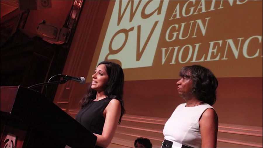 Woman who survived shooting stands at podium beside woman speaking about gun violence