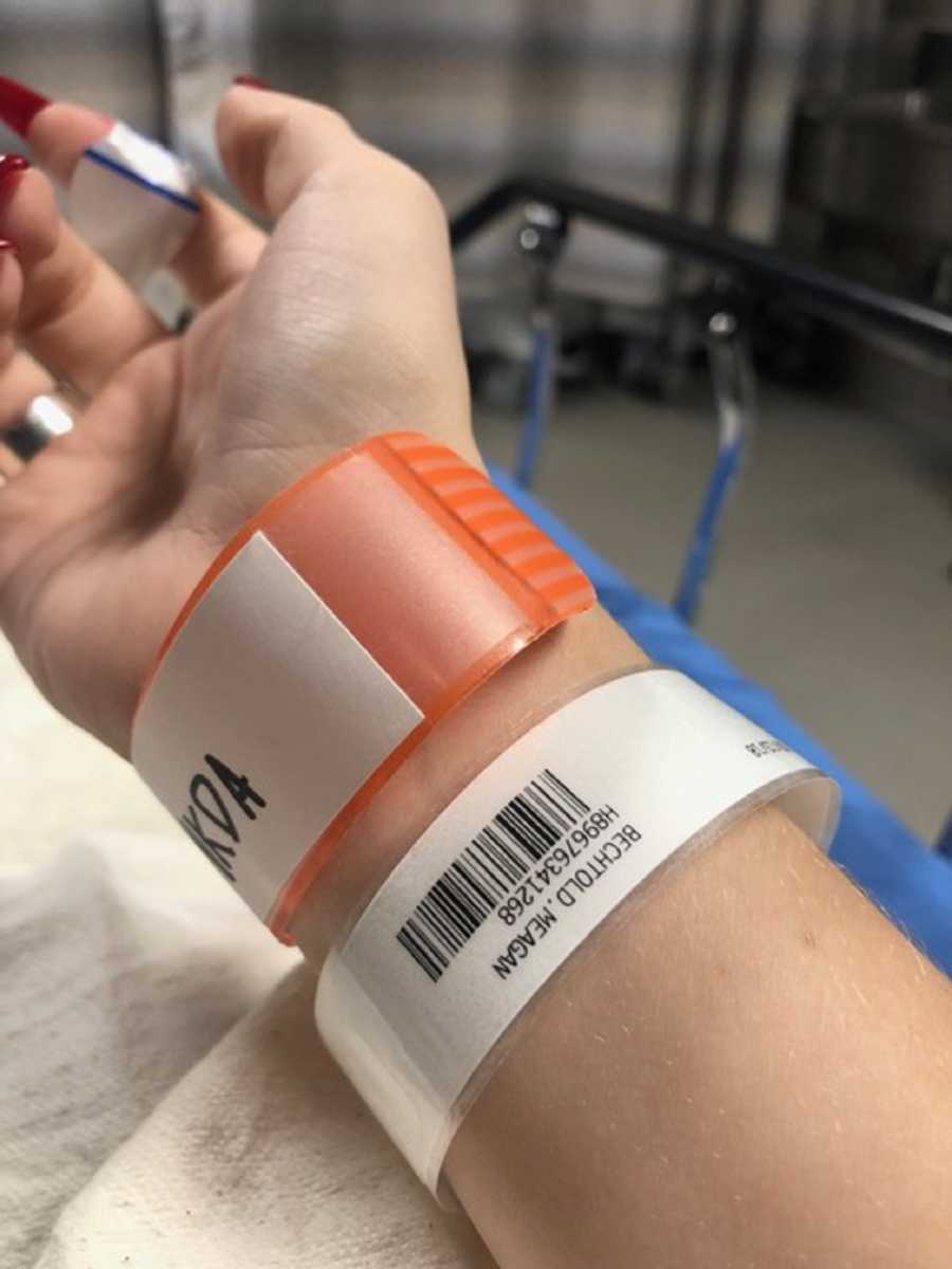 Close up of hospital bracelets on woman with hodgkin's lymphoma