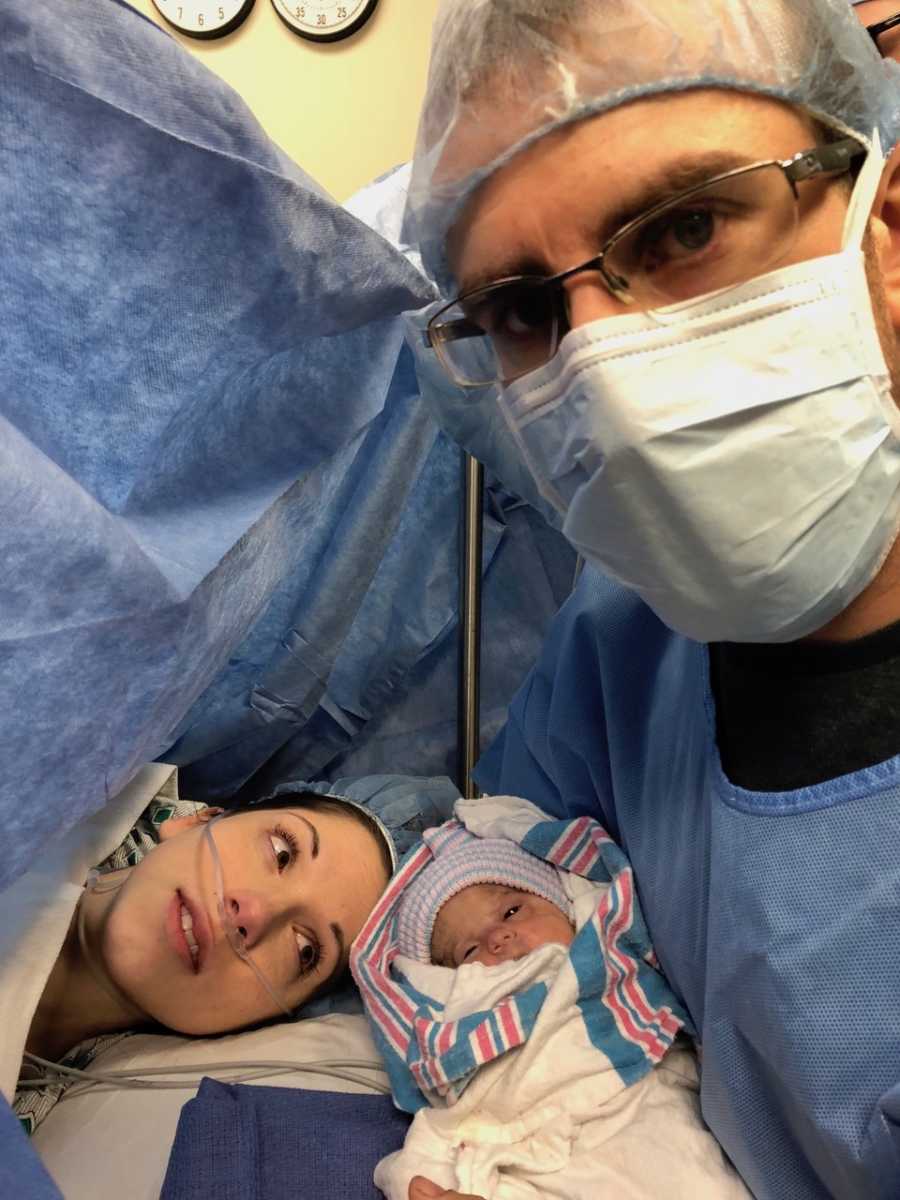 Father holds newborn in selfie by wife's face who had c-section