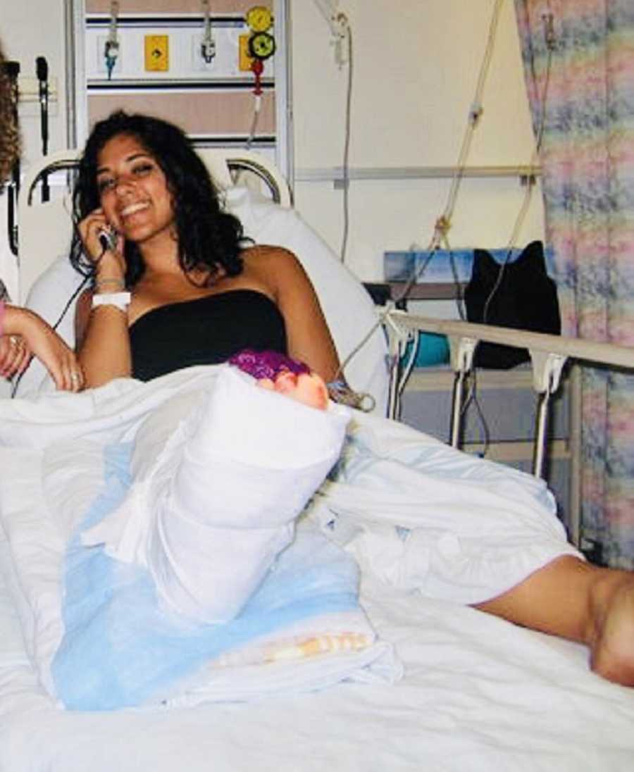 Woman who survived night club shooting sits smiling in hospital bed