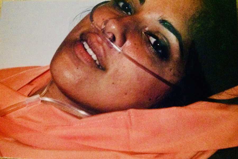 Woman lays on her back on oxygen after being shot