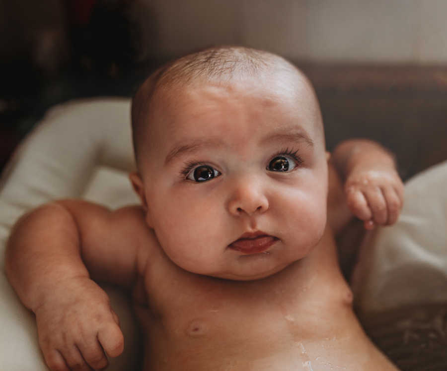 Close up of baby girl with eyes wide