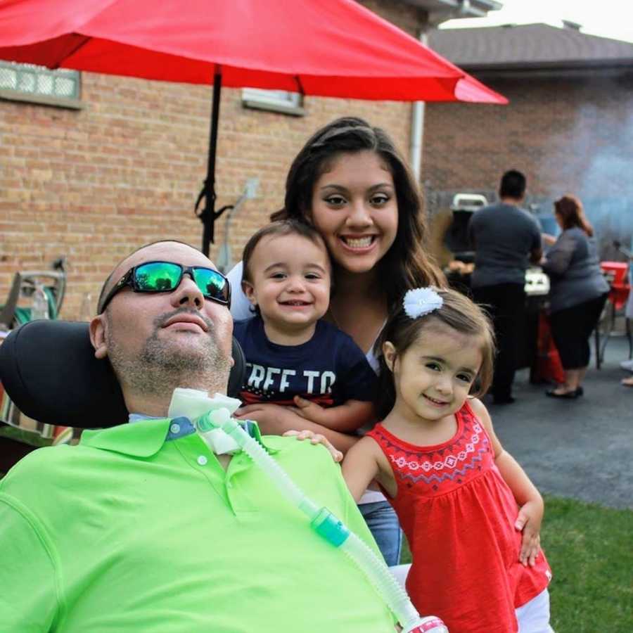 Man with trach from being shot 5 times sits in wheelchair outside home beside sister and her kids