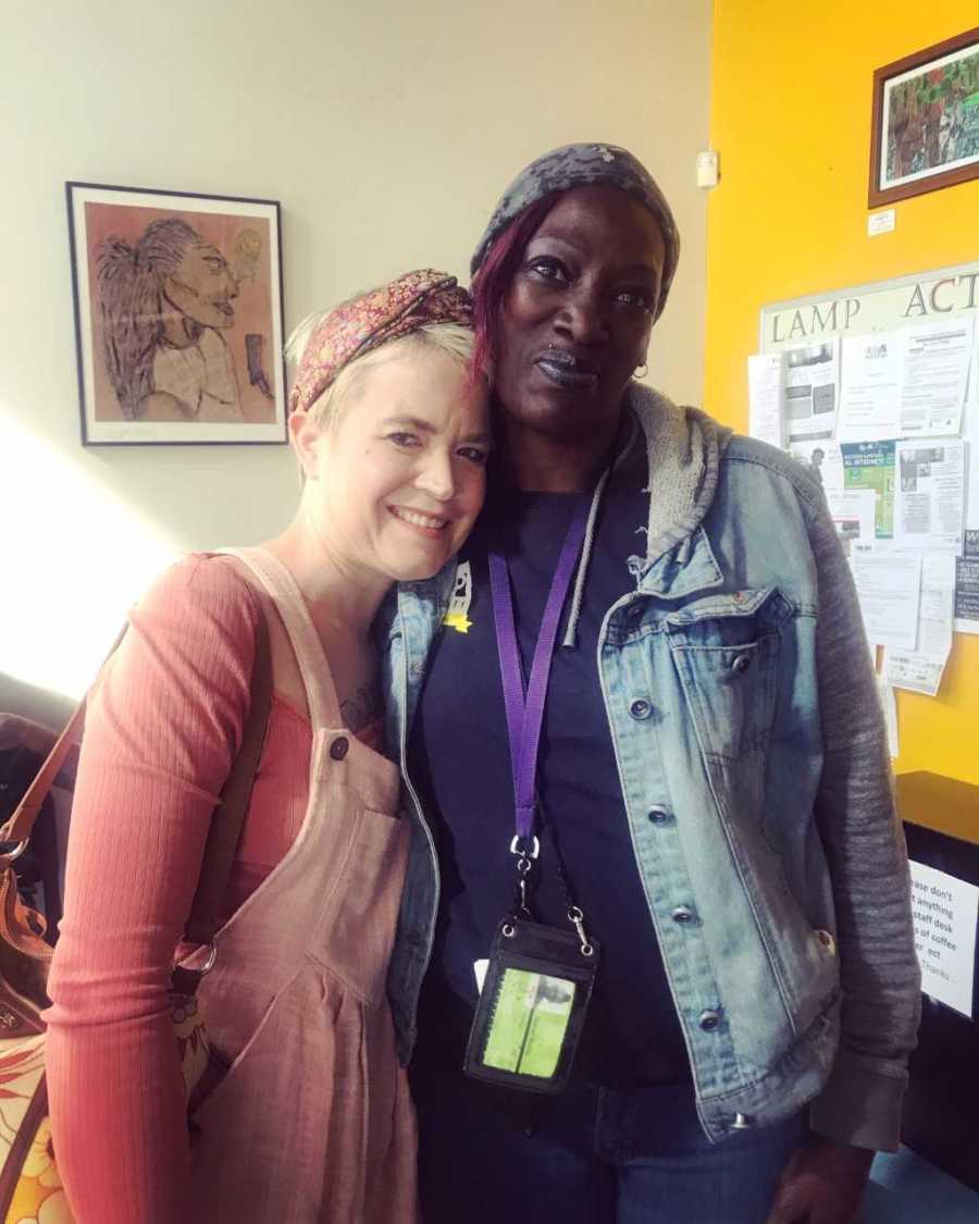 Homeless woman with bipolar disorder smiles beside woman who offered her help