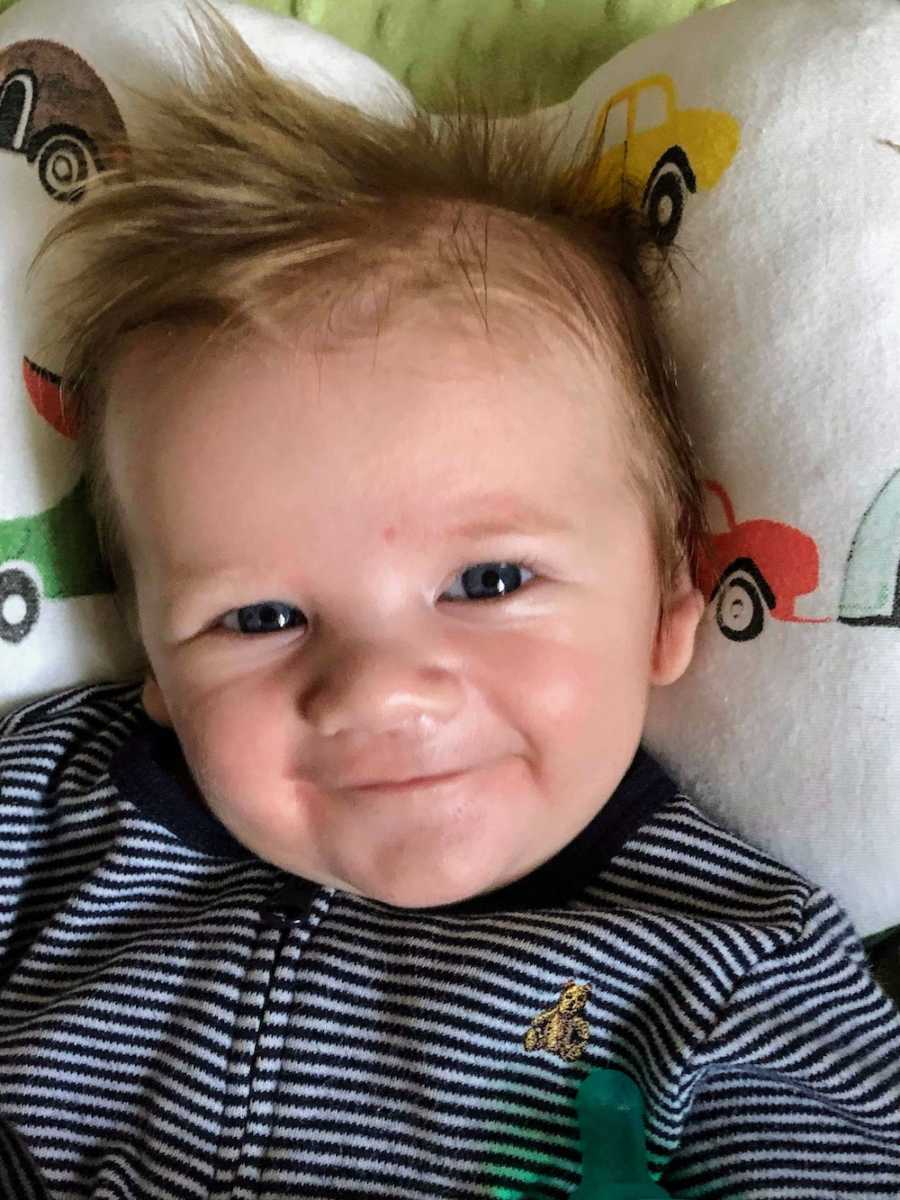 Baby lays smiling who was told had 0% chance of surviving
