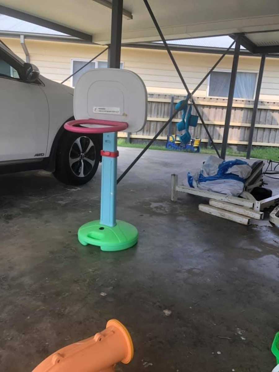 Driveway with car and miniature plastic basketball hoop