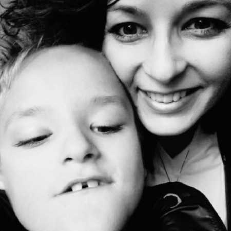 Mother smiles in selfie with son who has cerebral palsy