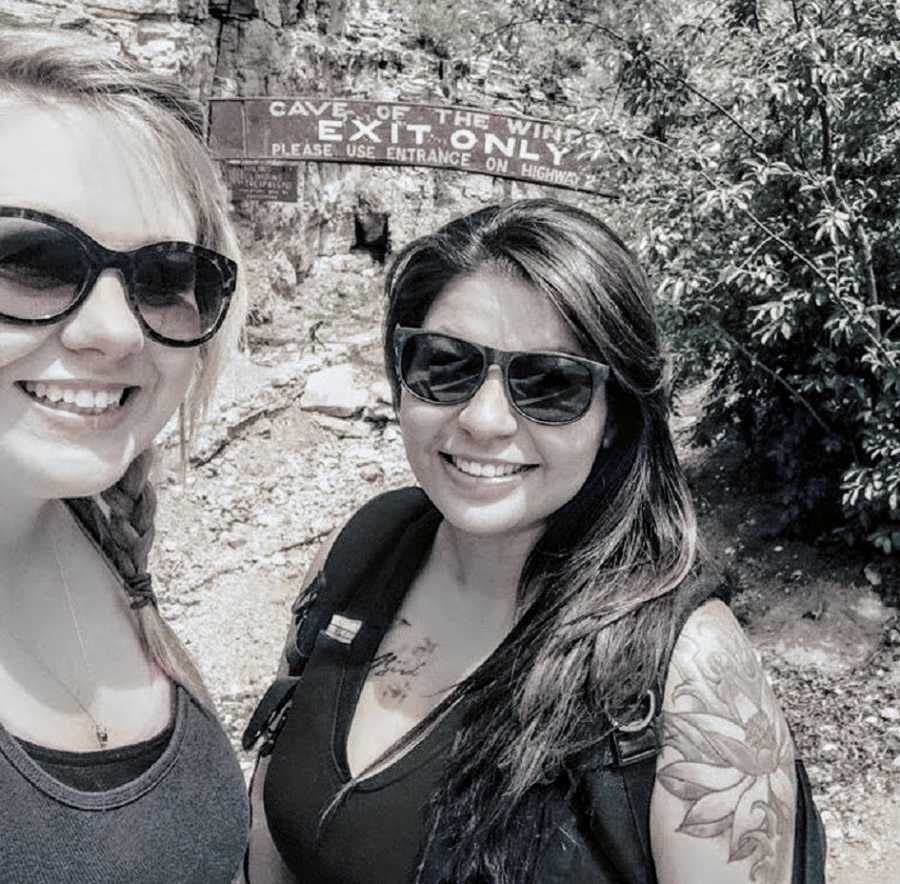 Woman smiles in selfie with friend whose older brother sexually abused her