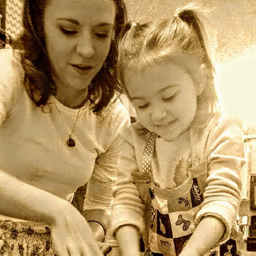 Woman who was named after her grandmother stands beside little girl as they bake