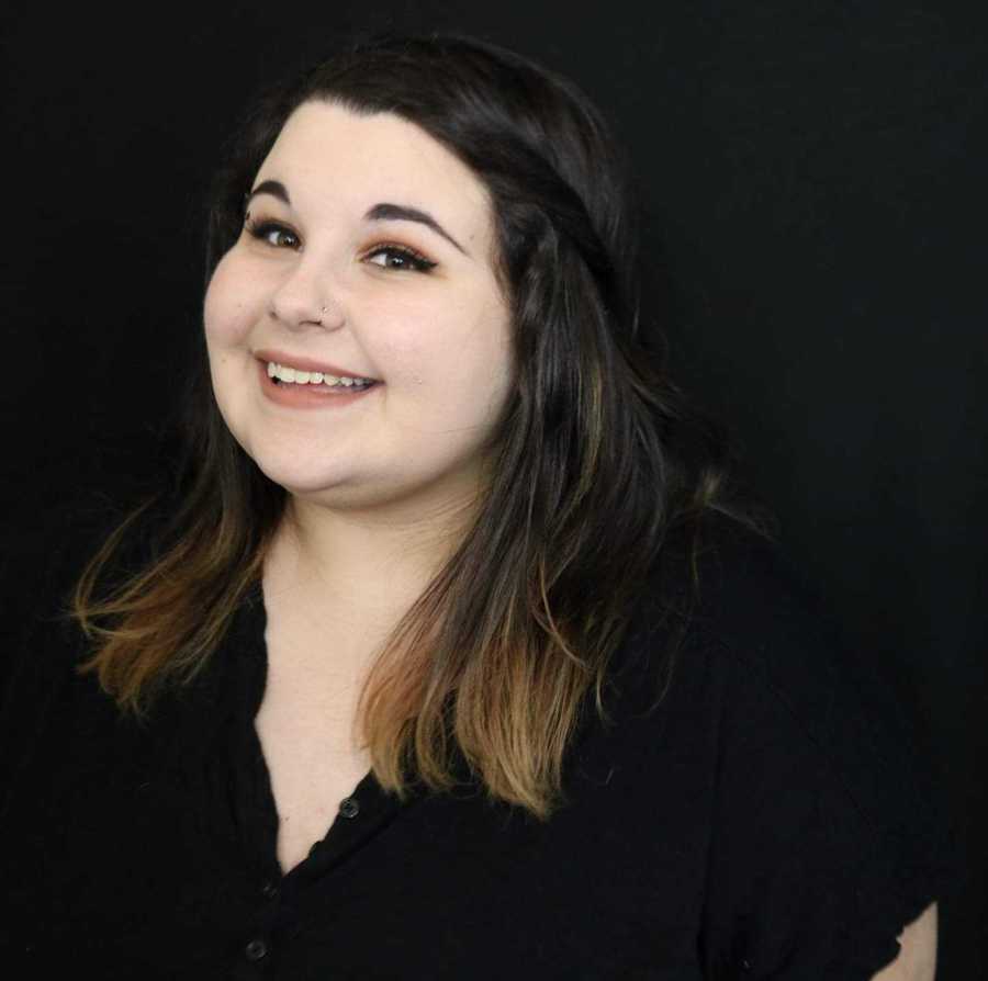 Young woman with OCD smiles for photoshoot