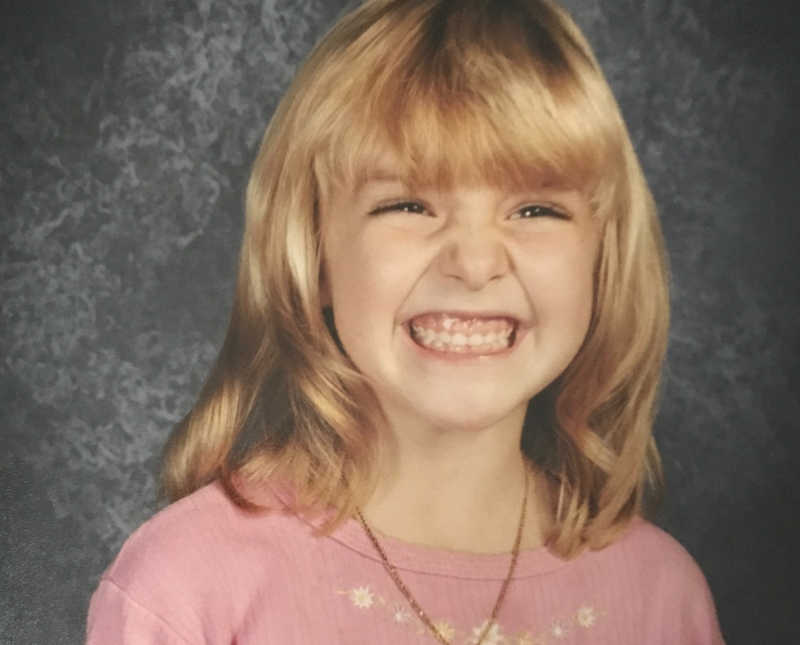 Little girl with big smile smiles for school picture