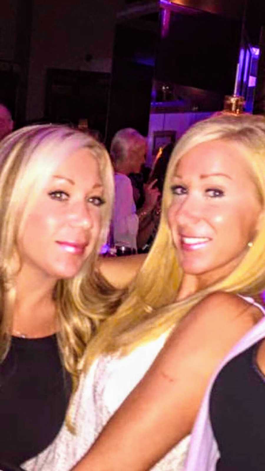 Twins stand smiling in club before one of them passed away
