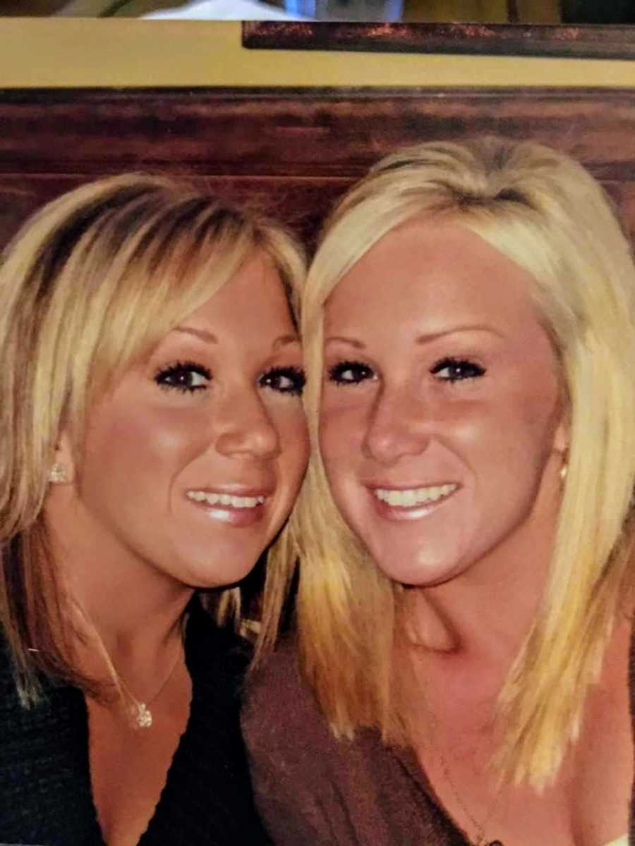 Woman smiles beside twin who has since passed away