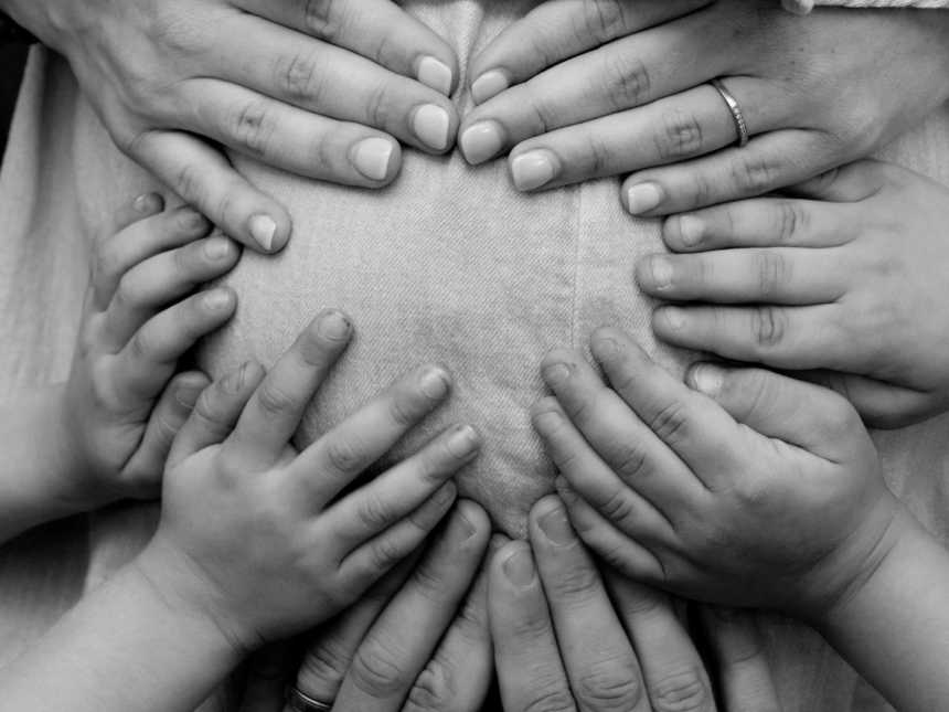 Close up of pregnant woman's stomach with hands on it