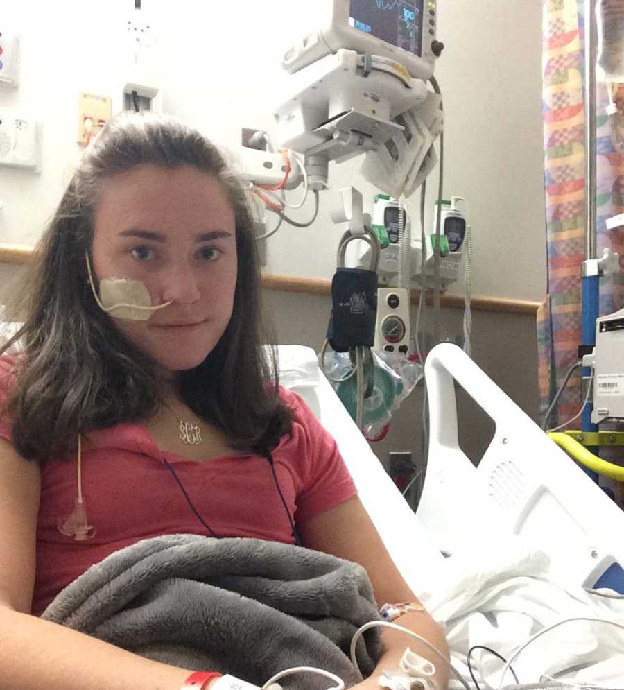 Intubated young woman sits in hospital bed with undiagnosed issue