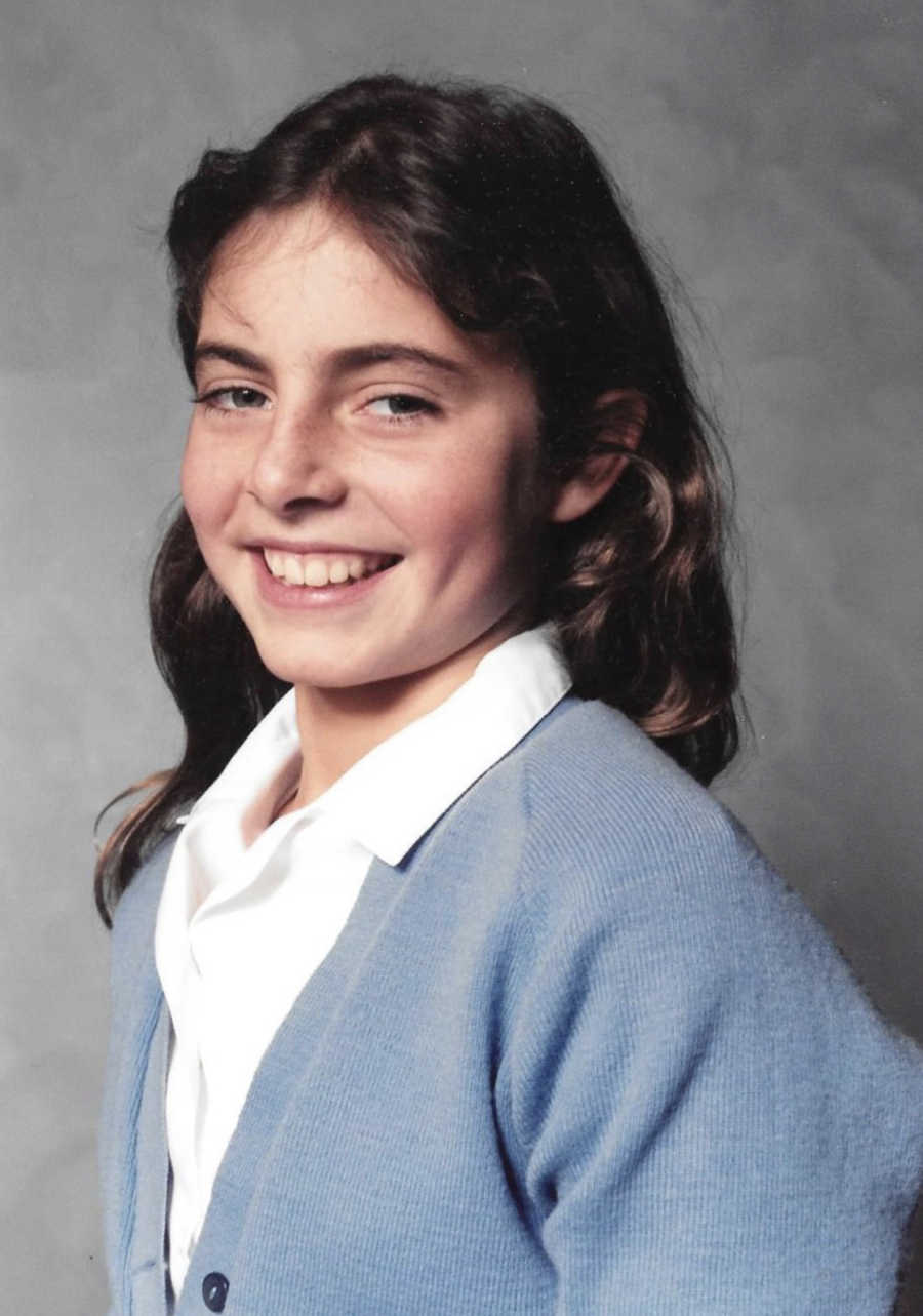 Young girl smiles for school picture after her father left