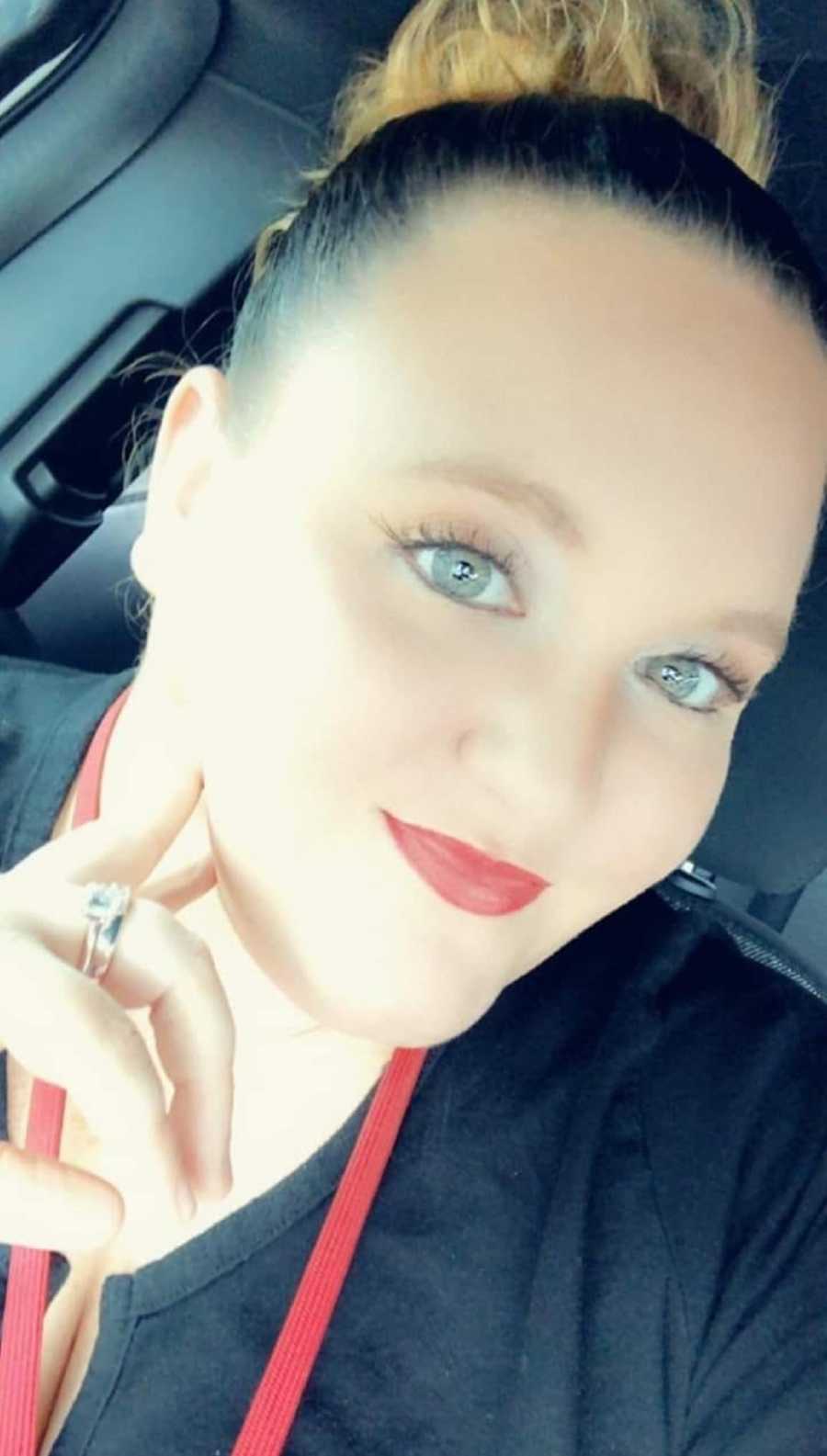 Woman who was sexually abused by her father as a child smiles as she takes selfie in car