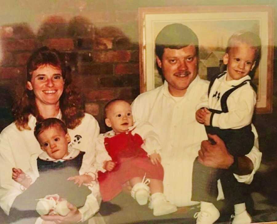 Father with diabetes and heart issues smiles as he holding his son and daughter beside wife who holds other daughter