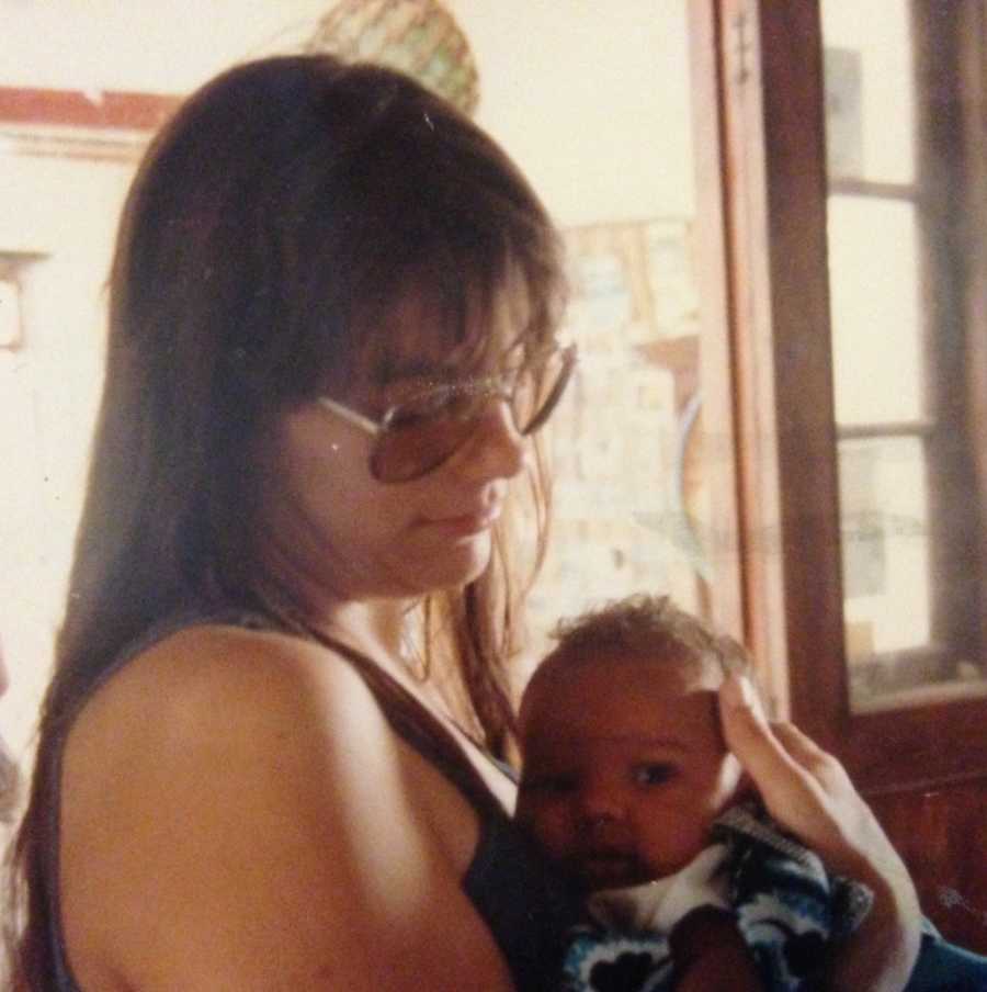 Mother holds baby boy to her chest