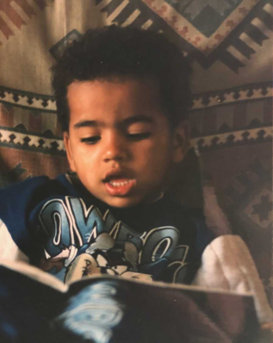 Little boy sits reading a book