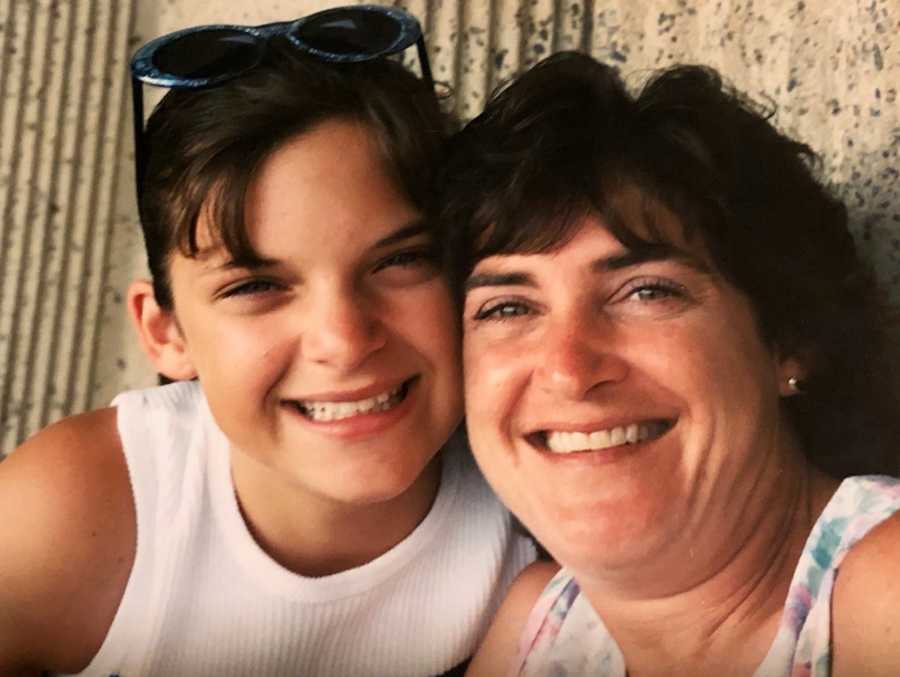 Young girl smiles beside her mom