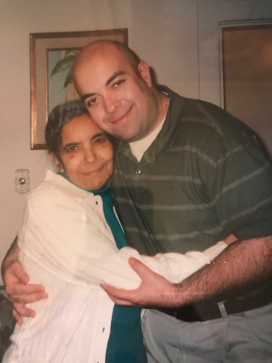 Man smiles as he hugs his mother with polycystic kidney disease