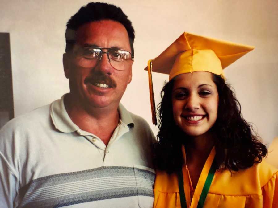 Man who struggled with alcoholism stands smiling beside daughter who is in cap and gown