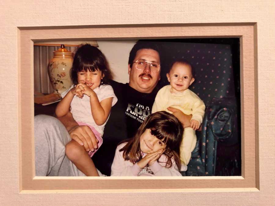 Man who was an alcoholic sits on floor of home with his three young kids