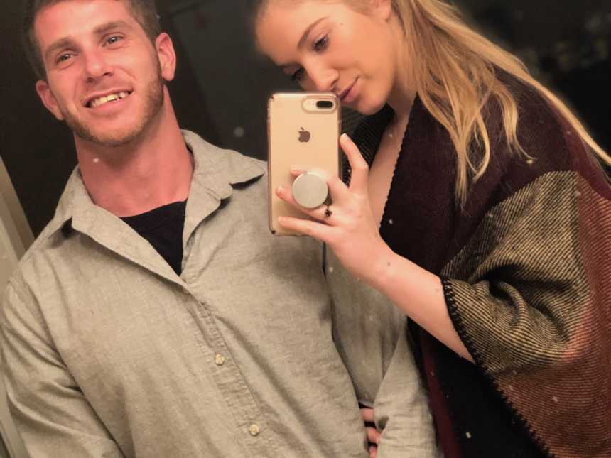 Recovered drug addict smiles as his girlfriend takes mirror selfie of them