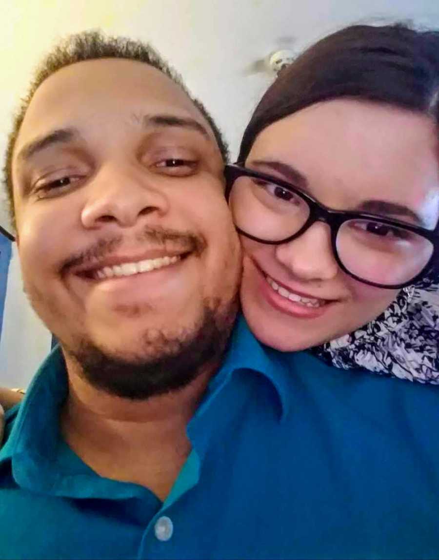 Mixed race husband and wife smile in selfie
