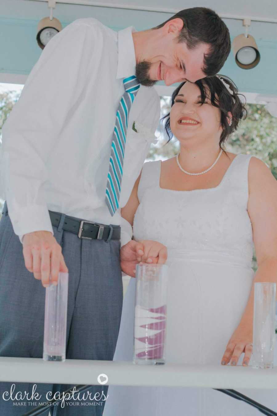 Bride with diabetes smiles as she lookds up at groom who stands beside her