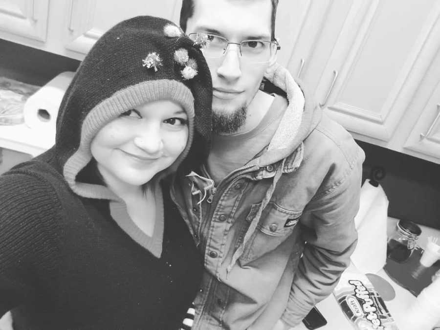 Woman with diabetes stands smiling in home in selfie with her husband 