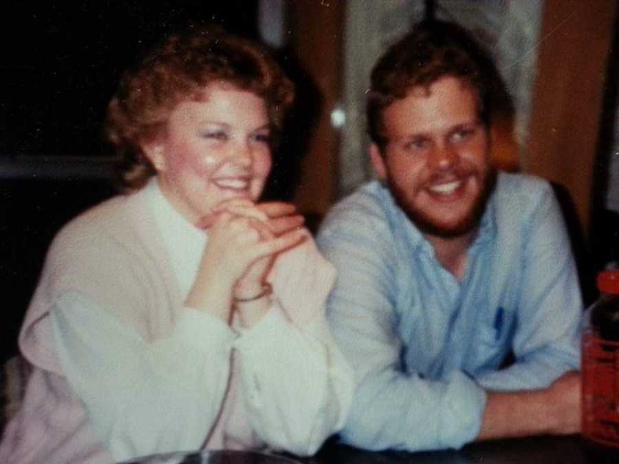 Husband and wife who have been married for 32 years smile as they sit beside each other when they were younger