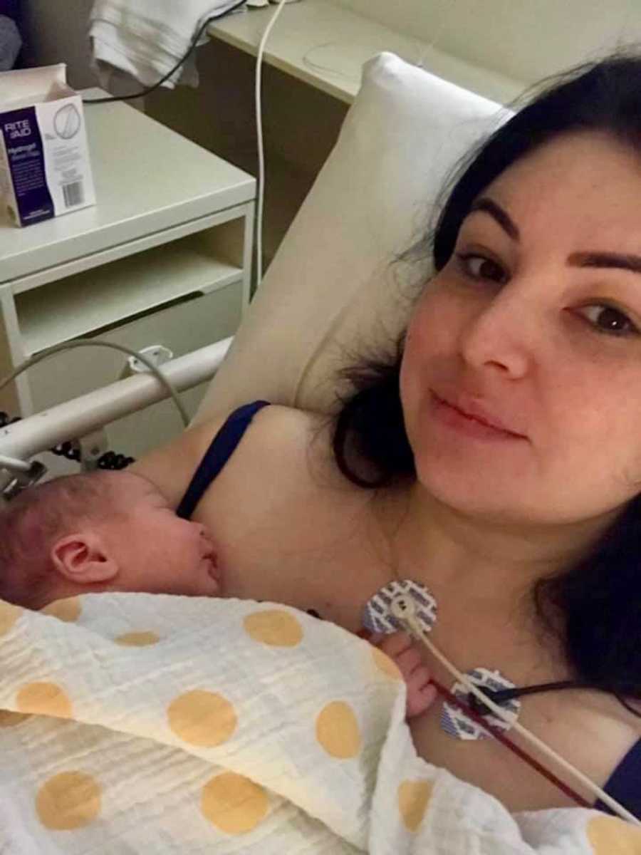 Woman who says people need to check on new mothers mental health lays in hospital bed with newborn laying on her chest