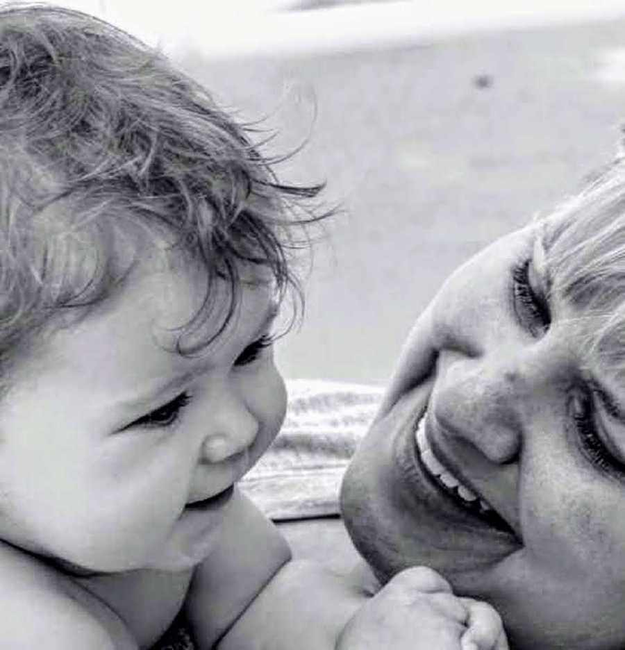 Woman who lost her sister to drugs smiles as she looks at her baby