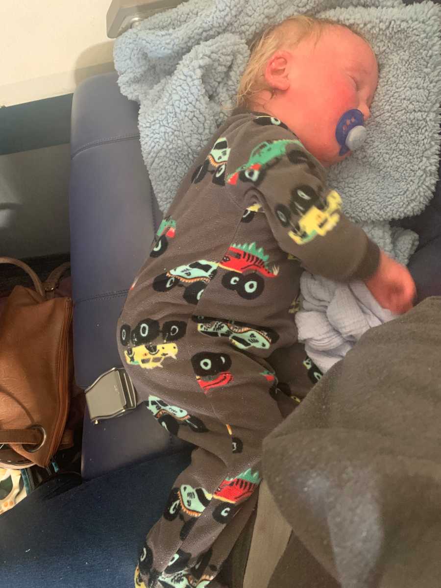 Baby with Ichthyosis lays on asleep on airplane seat before getting kicked off of plane