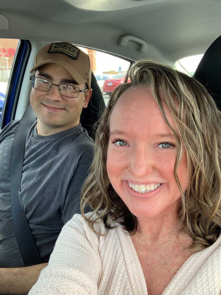 Woman smiles in car with husband who is about to be deployed 