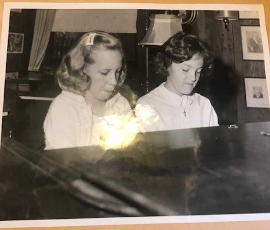 Young girl sits at piano with older woman