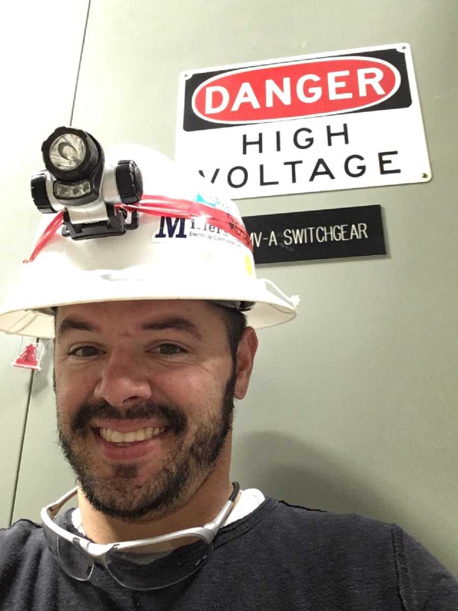 Man who works at nuclear plant smiles in selfie with hard hat on